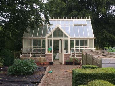 Garden specialists in Cardiff Florek Renovations mature garden with glass house